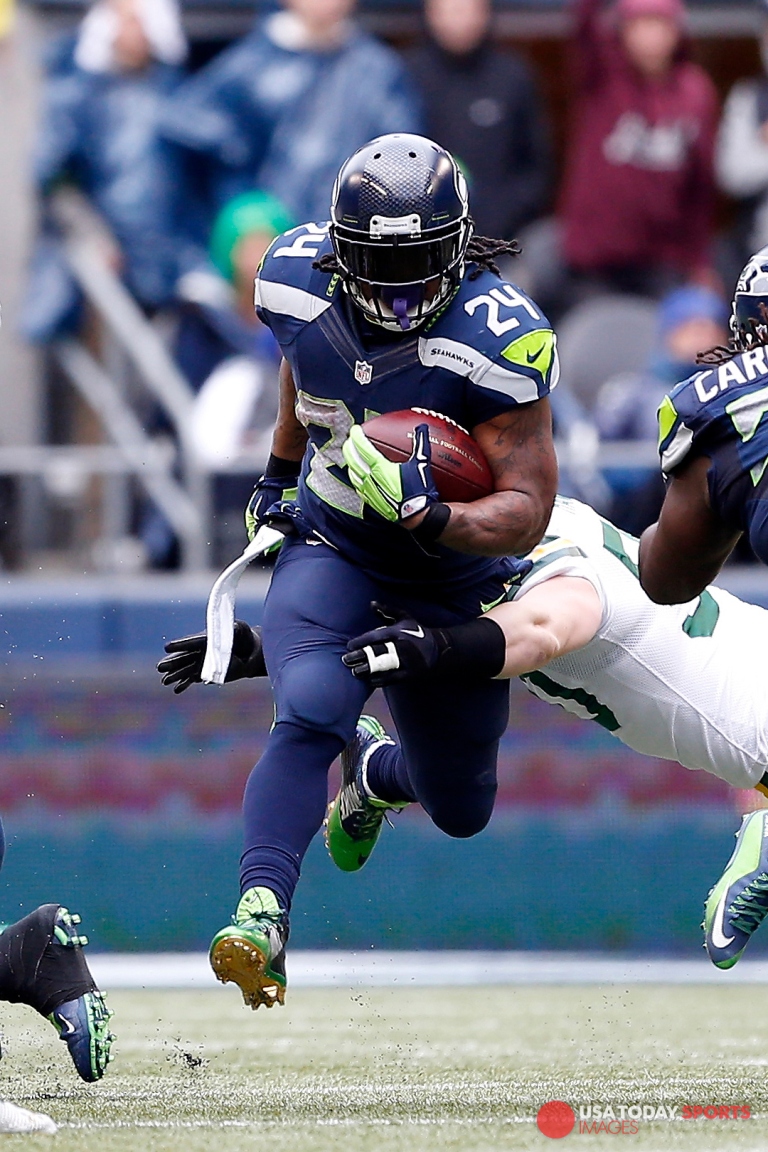 Jan 18, 2015; Seattle, WA, USA; Seattle Seahawks running back Marshawn Lynch (24) rushes against the Green Bay Packers during the third quarter in the NFC Championship game at CenturyLink Field. Mandatory Credit: Joe Nicholson-USA TODAY Sports