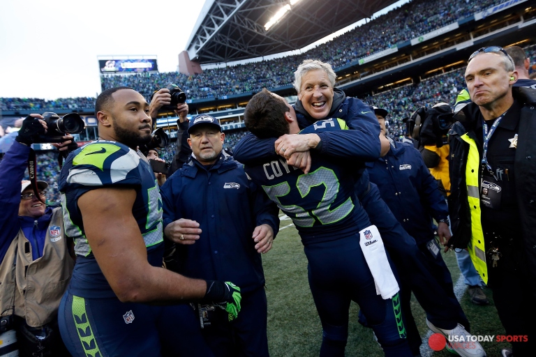 Jan 18, 2015; Seattle, WA, USA; Seattle Seahawks head coach Pete Carroll gets a hug from Seattle Seahawks middle linebacker Brock Coyle (52) following a 28-22 overtime victory against the Green Bay Packers in the NFC Championship game at CenturyLink Field. Mandatory Credit: Joe Nicholson-USA TODAY Sports